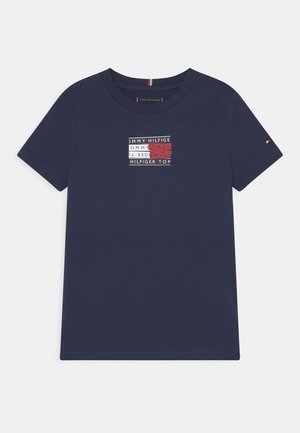 Navy blue cotton t-shirt with short sleeves and crew neck. Features a graphic print of "Tommy Hilfiger" in white, red, and black.