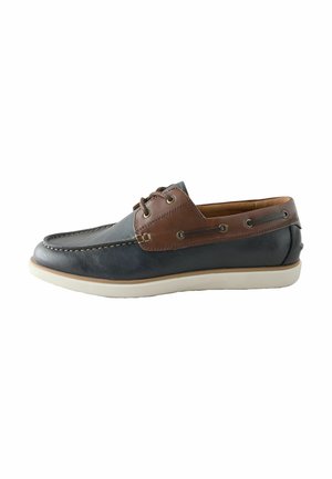 Men’s leather boat shoe with dark blue front and brown sides, lace-up detail, and white rubber sole.