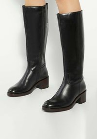 Black leather knee-high boots with a smooth texture, square toe, and a chunky heel. Features a side zipper for easy wear.