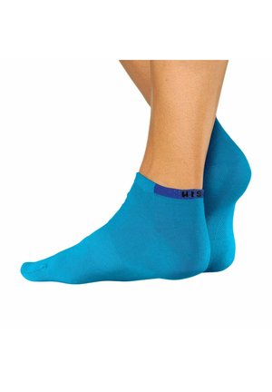 Türkise Knöchelsocken aus glattem Stoff, mit einem lila gemusterten Bündchen und einer engen Passform um den Knöchel.