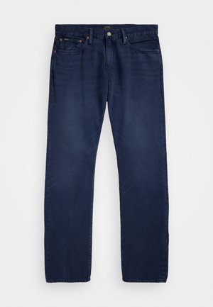 Jeans de denim azul escuro com pernas retas, bolsos frontais e fecho de botão. Apresenta costuras discretas e um emblema de marca na cintura.