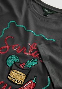 Dark gray cotton t-shirt featuring colorful sequin embroidery of a cocktail glass, holly, and the word "Santa" in red and green.