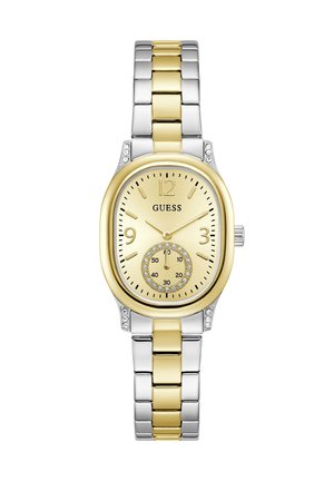Montre Guess en métal bicolore argent et or avec un cadran ovale doré, des accents en cristal, des marqueurs d'heure dorés et un petit cadran des secondes à six heures.