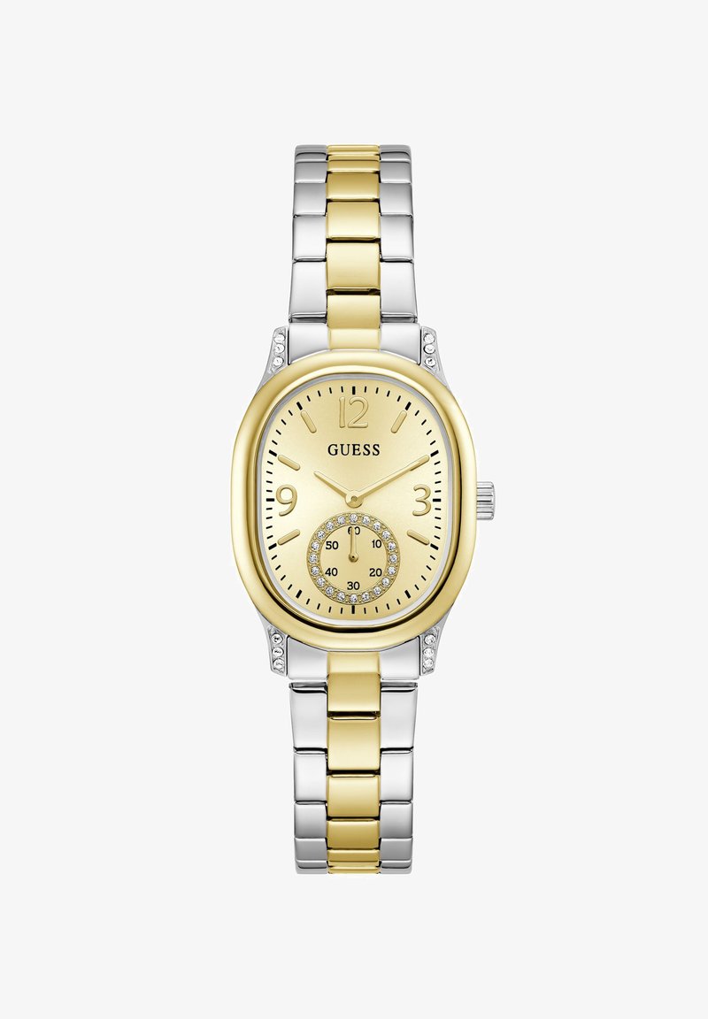 Montre Guess en métal bicolore argent et or avec un cadran ovale doré, des accents en cristal, des marqueurs d'heure dorés et un petit cadran des secondes à six heures.