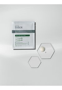 Hemp Fiber Sheet Mask package in white with green accents; two clear hexagonal plates with a small drop of cream on one.