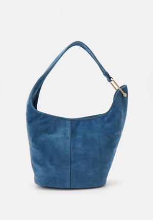 Blue suede bucket handbag with single wide shoulder strap and gold-tone metal hardware on strap attachment.