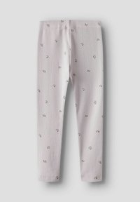 Leggings côtelés rose clair avec de petites impressions florales éparpillées, présentés à plat sur un fond neutre.