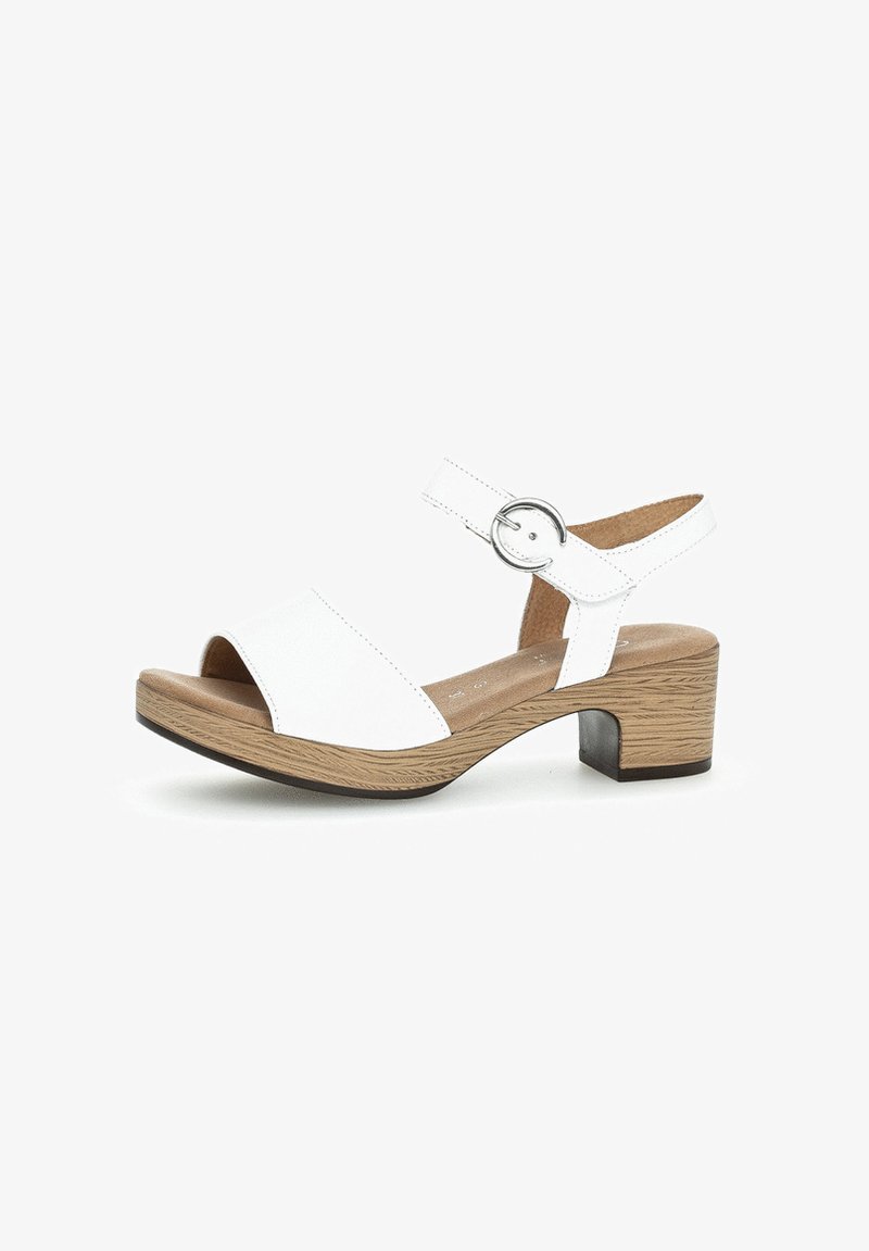 White open-toe sandal with a wide strap, adjustable ankle strap, silver buckle, and a block heel with a wood-like finish.