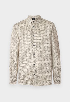Chemise à manches longues avec motif géométrique beige et noir, col classique et boutons noirs, présentée sur un fond clair uni.
