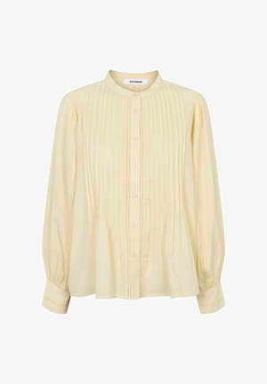 Bledě žlutá dlouhý rukáv halenka s vertikálními záhyby, kulatým límečkem a légou na knoflíky, s nařasenými rukávy a jemnými šicími detaily.