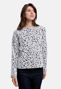 Langärmliges Oberteil in Schwarz und Weiß mit einem strukturierten Blättermuster. Strukturiert geschnitten mit rundem Halsauschnitt und festen Saum.