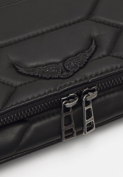 Black quilted leather bag featuring a glossy wing design and dual silver zippers with a textured pull, highlighting sleek craftsmanship.