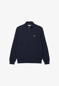 Sudadera azul marino con media cremallera, que presenta mangas largas y un pequeño logo verde de Lacoste en el lado izquierdo del pecho. Textura suave y color sólido.