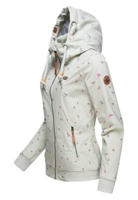 Chaqueta con capucha de color verde claro con patrones florales, cierre de cremallera y puños elásticos. Incluye elementos decorativos y detalles en los bolsillos.