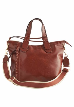 Bruine leren handtas met twee handvatten, decoratieve leren stiksels aan de zijkant, en afneembare stoffen schouderriem met beige randen.