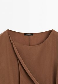 Brown suede fabric top with round neckline and overlapping front detail, showing a black label with brand name Massimo Dutti.