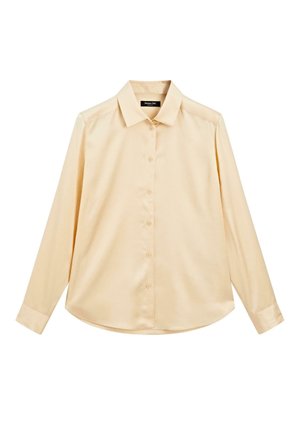 Chemise crème à boutons, en tissu lisse. Elle présente un col pointu, des manches longues et un ourlet arrondi. Design simple sans motifs.