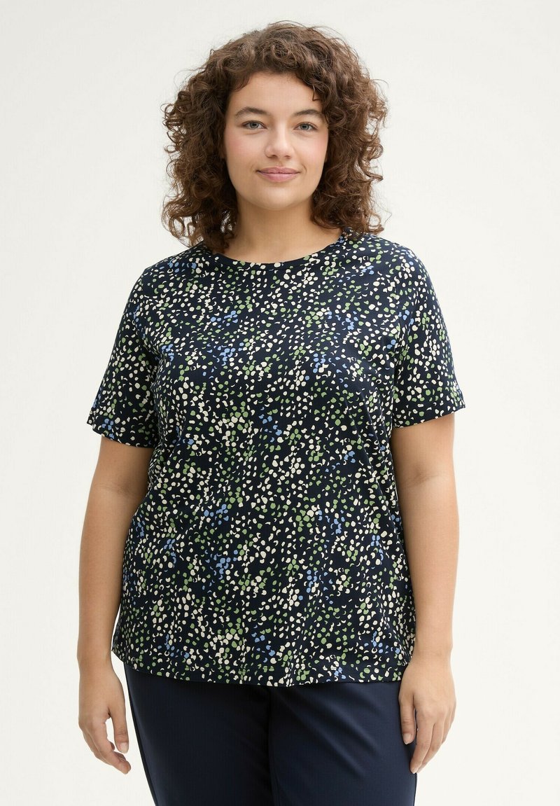 T-shirt a maniche corte blu navy con un motivo testurizzato di punti bianchi, verdi e blu, dotato di scollatura rotonda e vestibilità rilassata.