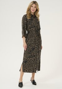Lang leopardenprint jurk in bruin en zwart, met een kraag, driekwart mouwen, strik in de taille en zijsplitten.