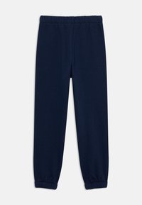 Navy blue sweatpants made of soft cotton, featuring an elastic waistband and elastic cuffs at the ankles for a tapered fit.