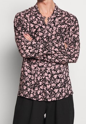 Black shirt with pink flower pattern, long sleeves, collared design, and button front. Fabric appears smooth with a lightweight texture.