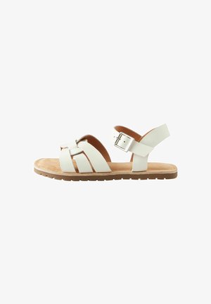 Sandalo in pelle bianca con design a fascetta incrociata, cinturino posteriore regolabile con fibbia e suola marrone imbottita.