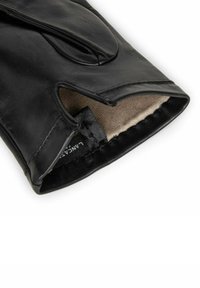 Gant en cuir noir avec une surface texturée, poignet ouvert et doublure beige. Comprend une étiquette avec le logo "Lange".