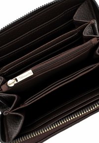 Brown leather wallet with multiple compartments, a zippered section, and a lined interior. Features a silver zipper and brand tag.