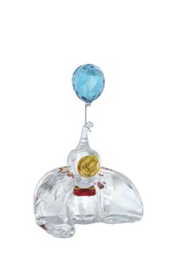 Przezroczysta figurka słonia z kryształu z żółtym detalem w środku, czerwonymi i różowymi akcentami oraz niebieskim, fasetowanym balonem na srebrnym drucie.