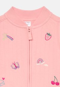 Light pink quilted jacket with ribbed collar. Features embroidered motifs: butterflies, strawberries, rainbows, and cherries. Front zipper closure.