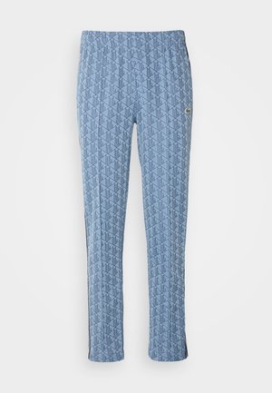 Blaue gemusterte Hose mit einem Diamantdesign, elastischem Bund und seitlichen Streifen. Hergestellt aus leichtem Stoff mit glatter Textur.
