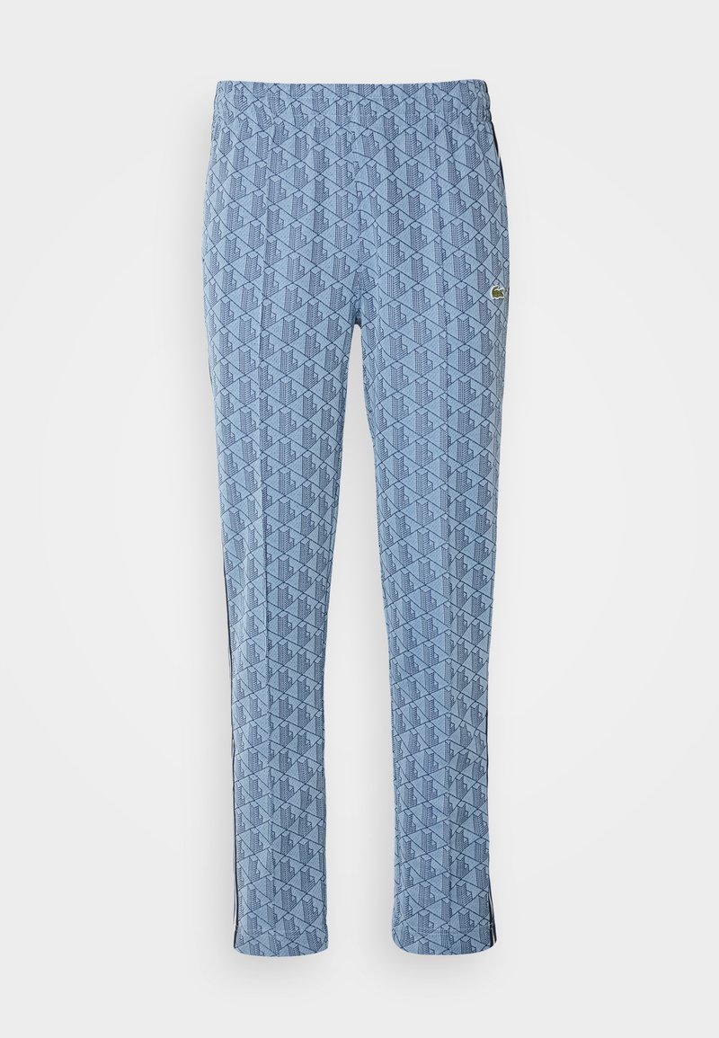 Blaue gemusterte Hose mit einem Diamantdesign, elastischem Bund und seitlichen Streifen. Hergestellt aus leichtem Stoff mit glatter Textur.
