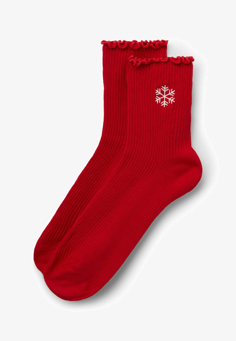 Calze rosse a coste con un bordo volant, caratterizzate da un motivo di fiocchi di neve ricamato di colore bianco sul lato. Tessuto morbido.