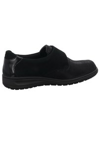 Black slip-on shoes featuring a combination of matte and textured materials, rounded toe, and a cushioned sole with traction patterns.