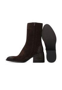 Hnědé semišové kotníkové boty s kulatou špičkou, bočním zipem a blokovým podpatkem. Podešev je texturována pro lepší přilnavost.