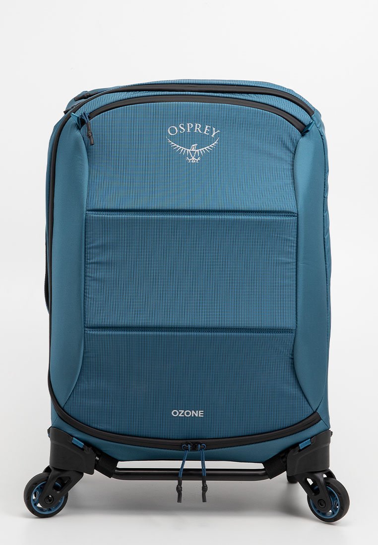 Osprey Ozone Koffer in Blaugrün, mit einem strukturierten Stoffdesign, einem ausziehbaren Griff, vier Rollen und einem mit Reißverschluss gesicherten Hauptfach.