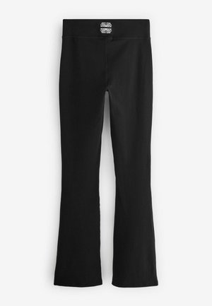 Zwarte wijde leggings gemaakt van rekbare stof. Kenmerken een effen kleur, brede tailleband en een minimalistisch ontwerp zonder zichtbare patronen.