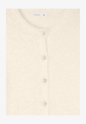 Kardigan w kolorze kremowym, wykonany z miękkiego, puszystego materiału. Posiada guziki przypominające biżuterię, okrągły dekolt oraz długie rękawy. Widoczna etykieta rozmiaru S.