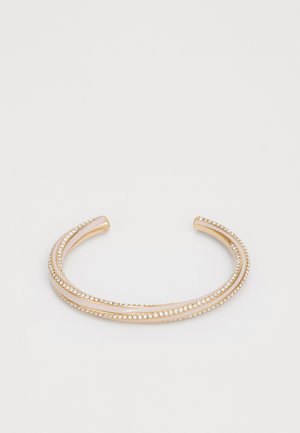 Gold cuff bracelet with two curved bands, adorned with crystal accents along the edges, smooth finish, and a sleek, open design.