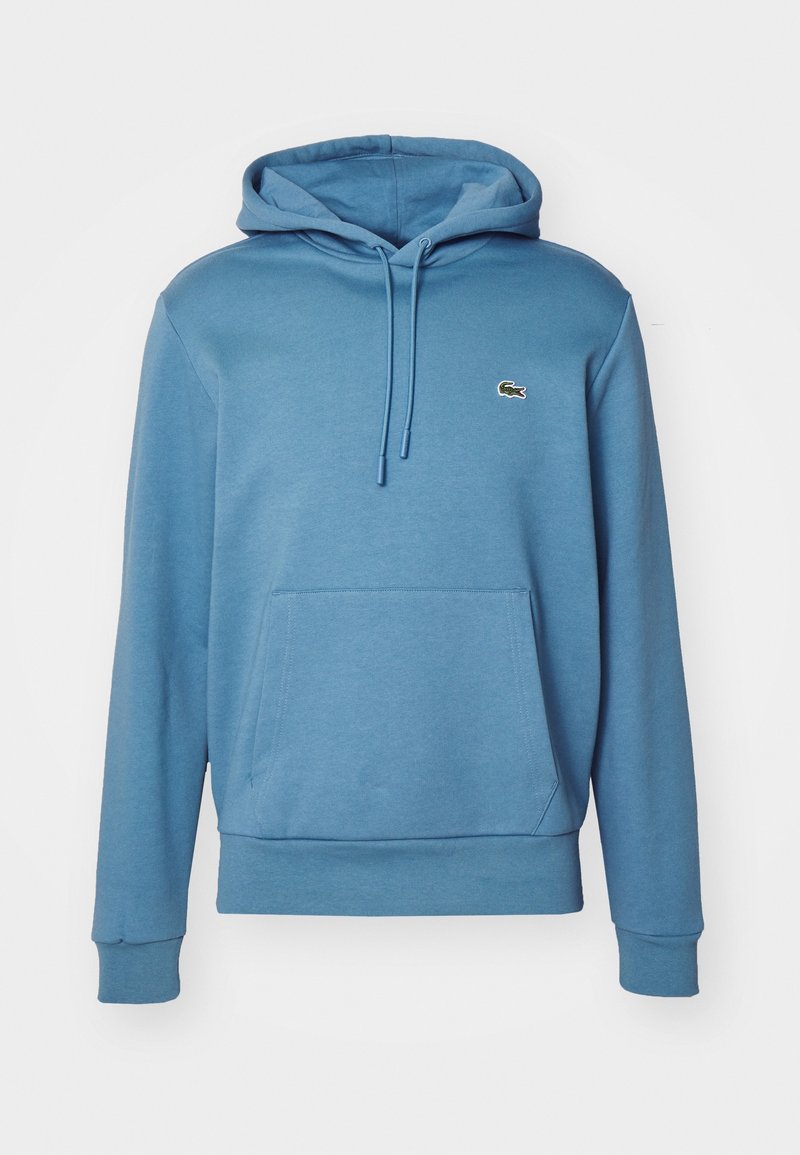 Sweat à capuche bleu à manches longues avec poche kangourou devant et petit logo crocodile vert sur la poitrine gauche.