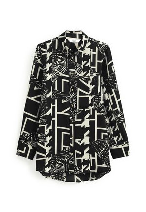 Chemise noire et blanche à manches longues avec boutons, ornée de motifs géométriques et abstraits de feuilles, avec une poche avant et un col.