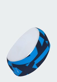 Diadema con una sección superior blanca y una banda azul marino con patrones geométricos azules llamativos. Hecha de un material elástico para mayor comodidad.