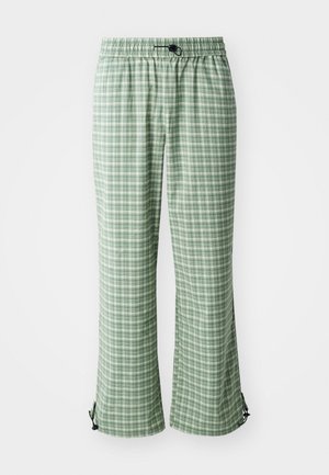 Green checked pants with an elastic waistband. Featuring a loose fit and adjustable ties at the ankle. Lightweight fabric texture.