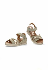 Sandalias verde claro con un acento metálico, que presentan tiras cruzadas y un tacón de cuña. Hebilla ajustable, plantillas acolchadas y suela texturizada.