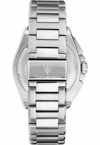 Rostfritt stål armbandsur med ett polerat och borstatuet metallarmband, oktagonalt fäste, gravyr med logotyp och krona på högra sidan.