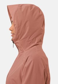 Giacca impermeabile di un leggero rosa con cappuccio, zip laterale e tessuto testurizzato. Presenta un design aderente e dettagli di cucitura minimi.