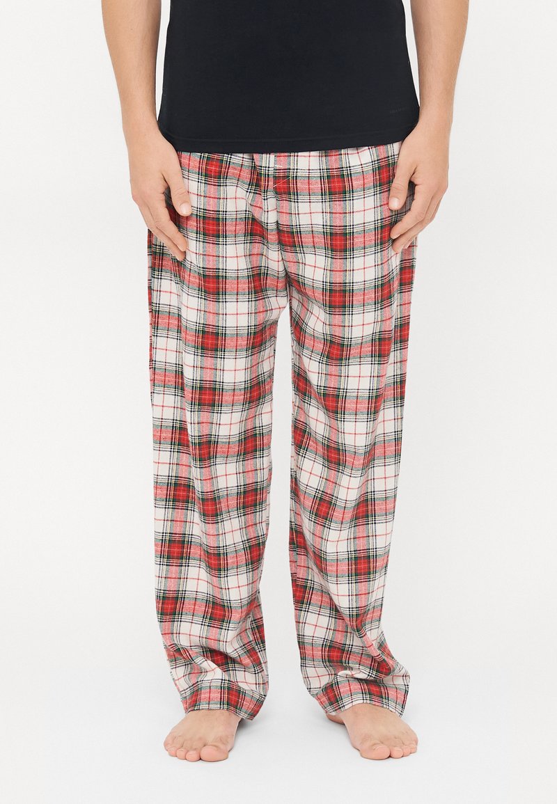 Rote, schwarze und weiße Karotten-Pyjama-Hosen aus weichem Stoff, mit einem elastischen Bund und weitem Bein.