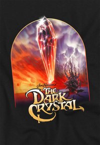 Black background features a vibrant illustration of a crystal with red and orange hues, and the text "The Dark Crystal" in stylized yellow font.