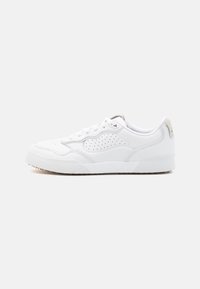 White athletic shoes made of leather, featuring perforated detailing, a rounded toe, padded collar, and a textured rubber outsole.