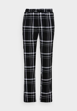Zwart-wit geruite broek met een relaxte pasvorm, voorzien van een elastische tailleband en een trekkoord. Het materiaal lijkt zacht met een gladde textuur.